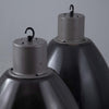 Extra large pendant light with a steel black enamelled dome shaped shade with white interior on a grey background