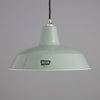 a 1950s mint green enamel industrial pendant light by REVO on a grey background.