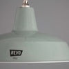 a 1950s mint green enamel industrial pendant light by REVO on a grey background.