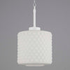 a small white opaline cylindrical pendant light with white bakelite fixing. The opaline glass is a geometric design with hole at the bottom that lets light seep through for efficient downlighting