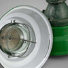 A vintage industrial 1950's green enamel ceiling light reclaimed from a former mine featuring a glass dome and metal cage to protect the lamp holder. Restored for modern use.