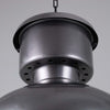 Close-up of a metallic pendant light with a gray background
