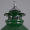 A green enamel light shade with vented top to allow illumination to seep upwards