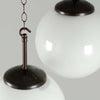Close up of the black bakelite gallery of a 250mm vintage milk glass globe pendant light