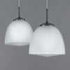 A large 1950s opaline glass pendant light with aluminium hanging gallery.