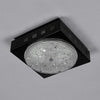 a square retro surface mount cut glass ceiling light with black metal enclosure.