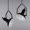 Black vitreous enamel vintage industrial pendant light with adjustable arm to tilt the illumination.