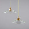 small glass ceiling lights with a brass hanging gallery. The circular glass shades have concentric circular pattern.