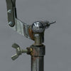 Close-up of a metal clamp or holder on a gray background