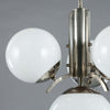Close up of 1920s Art Deco Opaline Globe Chandelier featuring 4 milk glass globes on a pewter ballust mounted to the ceiling