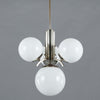 1920s Art Deco Opaline Globe Chandelier featuring 4 milk glass globes on a pewter ballust mounted to the ceiling