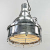 The large explosion proof cast aluminium pendant light was made by the Indian company Baliga Lighting Equipments Ltd. It is a very heavy solid metal light fixture which features a cage over the tempered glass lens that protects the lamp holder from external elements. 