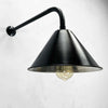 The wall mounted industrial style black downlight is a new fixture based on the design of the British Army festoon shades that were used in the field. Made in England by Loomlight, the conical steel lamp shade is painted satin black and is extended from the wall by a curved black wall arm fixture. Ideal for illuminating pictures on the wall or down lighting walls for ambiance. This wall fixture can be used on its own or alongside ceiling lights.