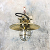 Vintage industrial style cantilever wall light with brass explosion proof cage light suspended to a copper pipe wall arm and brass wall fixing plate. Compatible with LED light bulbs. Restored & rewired ready to install.