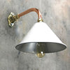 A white cantilever wall light with copper & brass wall fixture