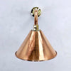 This copper wall lamp is in our Industrial style wall lighting collection. It has a curved copper wall arm connected to the conical copper lamp shade. Making this wall lamp a down light for creating ambiance with ceiling lights or lighting for illuminating pictures on the wall.