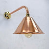 This copper wall lamp is in our Industrial style wall lighting collection. It has a curved copper wall arm connected to the conical copper lamp shade. Making this wall lamp a down light for creating ambiance with ceiling lights or lighting for illuminating pictures on the wall.