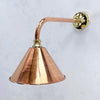This copper wall lamp is in our Industrial style wall lighting collection. It has a curved copper wall arm connected to the conical copper lamp shade. Making this wall lamp a down light for creating ambiance with ceiling lights or lighting for illuminating pictures on the wall.