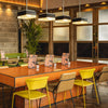 Four Square shaped Retro glass pendant lights in a retro style restaurant over an orange tiled table