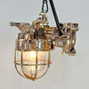 An industrial bronze ceiling light with a brass cage covering a tempered glass dome reclaimed from old ships and restored for modern interiors. Worldwide shipping is available. 15 of these fixtures are available for sale.