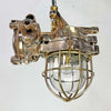 An industrial bronze ceiling light with a brass cage covering a tempered glass dome reclaimed from old ships and restored for modern interiors. Worldwide shipping is available. 15 of these fixtures are available for sale.