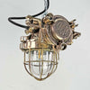 An industrial bronze ceiling light with a brass cage covering a tempered glass dome reclaimed from old ships and restored for modern interiors. Worldwide shipping is available. 15 of these fixtures are available for sale.