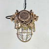 An industrial bronze ceiling light with a brass cage covering a tempered glass dome reclaimed from old ships and restored for modern interiors. Worldwide shipping is available. 15 of these fixtures are available for sale.