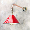 A cantilever wall light comprising a directional red lamp shade which is attached to a copper and brass wall arm fixture. The red shade is attached via a ball joint so rotates in all directions making this a great directional wall light.