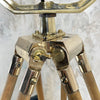 A tall nautical brass and steel searchlight mounted onto a British antique wooden surveyors tripod. A unique and original tall tripod floor lamp perfect for creating the "wow" factor with a nautical style fixture.