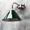 Introducing our industrial style wall downlight, a testament to functional design and military-inspired aesthetics. Featuring a deep green lamp shade based on the design of the British military green festoon shades that we once reclaimed. Mounted on a bespoke galvanised steel cantilever fixture, this versatile lighting solution combines military charm with contemporary practicality.
