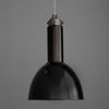 Black pendant light against a gray background