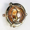 Reclaimed and restored vintage industrial brass bullseye bulkhead wall light. Featuring a bullseye style cage to protect the lamp holder.