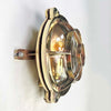 Reclaimed and restored vintage industrial brass bullseye bulkhead wall light. Featuring a bullseye style cage to protect the lamp holder.