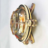 Reclaimed and restored vintage industrial brass bullseye bulkhead wall light. Featuring a bullseye style cage to protect the lamp holder.