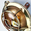 Reclaimed and restored vintage industrial brass bullseye bulkhead wall light. Featuring a bullseye style cage to protect the lamp holder.
