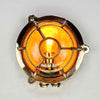 Reclaimed and restored vintage industrial brass bullseye bulkhead wall light. Featuring a bullseye style cage to protect the lamp holder.