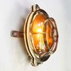 Reclaimed and restored vintage industrial brass bullseye bulkhead wall light. Featuring a bullseye style cage to protect the lamp holder.
