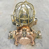 This robust bronze wall light is an original flameproof industrial lamp which has been restored for a modern interiors.