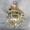 This robust bronze wall light is an original flameproof industrial lamp which has been restored for a modern interiors. It features a brass cage and all the original manufacturers castings on the plate