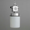 Vintage-style pendant light with metallic fixture and white glass shade on a gray background