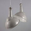 Large grey vitreous enamel factory pendant lights with angled shade for directional task lighting.