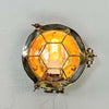 A brass industrial round bulkhead light with a protective hexagonal cage. Sometimes described as a bullseye lamp due to the design of the cage this original vintage brass wall light is reclaimed from marine environments and professionally refurbished and rewired by hand in our workshop ready for indoor use