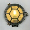 The industrial bulkhead light is a robust reclaimed industrial round wall light featuring a hexagonal cast aluminium cage and chevron reeded glass which diffuses the illumination beautifully. It is industrial lighting at its best, made for use on cargo ships and supertankers where they were used to illuminate passageways. We professionally restore each fixture by hand to British safety standards ready for contemporary interiors. 