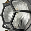 The industrial bulkhead light is a robust reclaimed industrial round wall light featuring a hexagonal cast aluminium cage and chevron reeded glass which diffuses the illumination beautifully. It is industrial lighting at its best, made for use on cargo ships and supertankers where they were used to illuminate passageways. We professionally restore each fixture by hand to British safety standards ready for contemporary interiors.