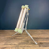 A green T8 steampunk floor lamp on a tripod. It is a reclaimed industrial flameproof tube lightmade by Daeyang circa 1976 fitted to a steampunk style tripod