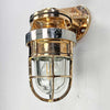 A robust bronze industrial outdoor light reclaimed from decommissioned cargo ships. This is a vintage industrial wall light made by the American company Pauluhn Electric Manufacturing. We have professionally restored this wall light so they are ready to install outdoors and use with LED light bulbs. Or use indoors for authentic industrial look & feel.