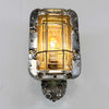 A large industrial rectangular wall light which is reclaimed from an old pub. Comprised of an aluminium case with tempered glass lens and protective brass cage. Fitted with LED filament light bulb.