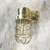 Shop our vintage brass ships light. A 90 degree lamp with cast brass cage and tempered glass cover. Industrial lighting reclaimed and restored for modern interiors. This wall lamp can be used outdoors. It is compatible with an LED light bulb. Manufactured by Daeyang a Korean company who made fixtures for industrial purposes.