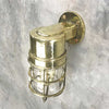 Shop our vintage brass ships light. A 90 degree lamp with cast brass cage and tempered glass cover. Industrial lighting reclaimed and restored for modern interiors. This wall lamp can be used outdoors. It is compatible with an LED light bulb. Manufactured by Daeyang a Korean company who made fixtures for industrial purposes.