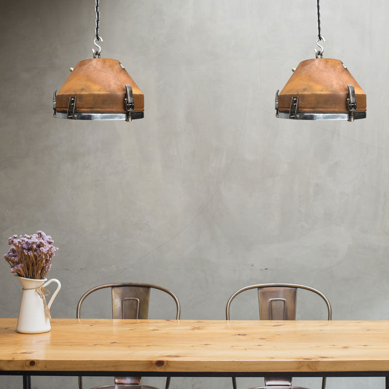 vintage industrial Rusted ceiling pendants over a rustic dining table and concrete wall
